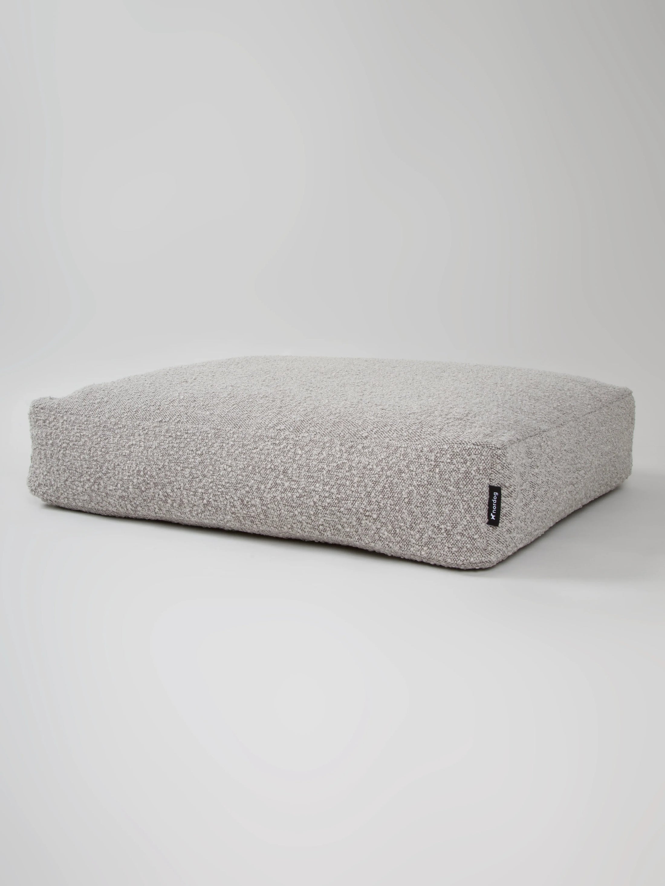 Luxurious Billy Bouclé dog cushion in soft grey bouclé fabric, offering comfort and style for pets.