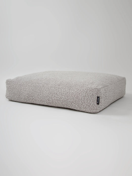 Luxurious Billy Bouclé dog cushion in soft grey bouclé fabric, offering comfort and style for pets.